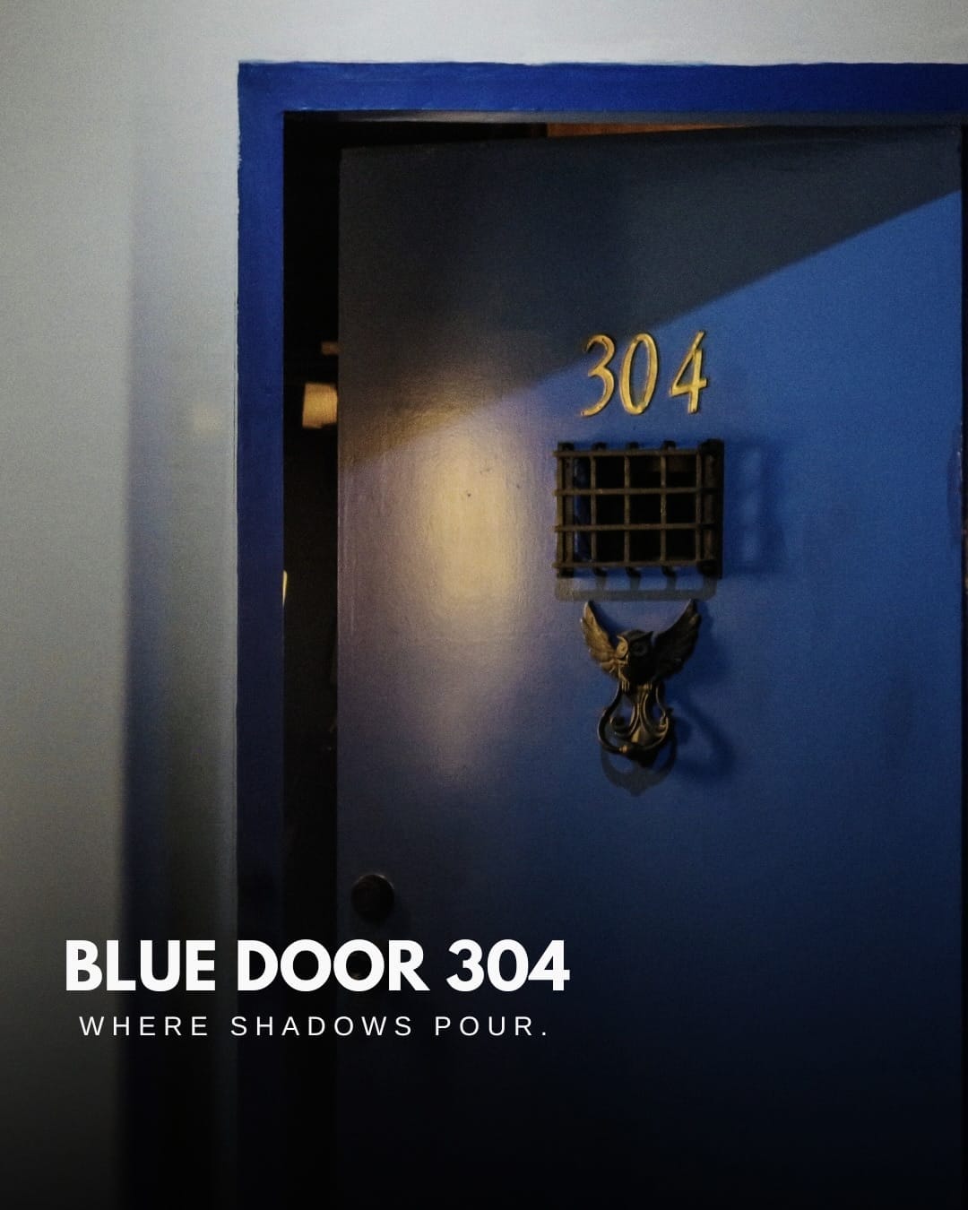 The iconic blue door with number 304 and bronze door knocker at Blue Door 304 speakeasy in Poblacion, Makati